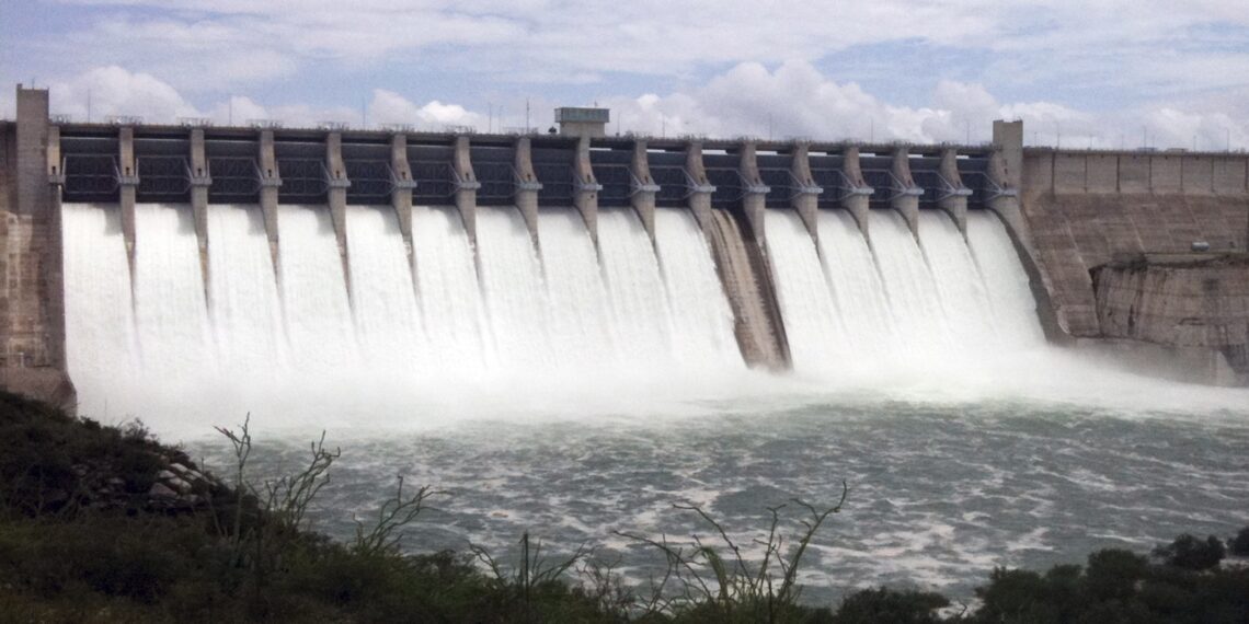 Water behind the binational Amistad Dam on the Rio Grande, already at its highest level since 1974, is released from 15 of the dam's 16 floodgates in the city of Ciudad Acuna, Mexico, near Del Rio, Texas, Wednesday July 7, 2010. Reservoirs along the Texas-Mexico border rose to their highest levels in decades after days of drenching rain, forcing officials to close two border bridges Wednesday, dump water into flooded rivers and evacuate tens of thousands from homes as a new storm headed toward the region.(AP Photo/Oscar Villalba)