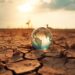 fragile planet over dry cracked agricultural field due to drought. generated ia